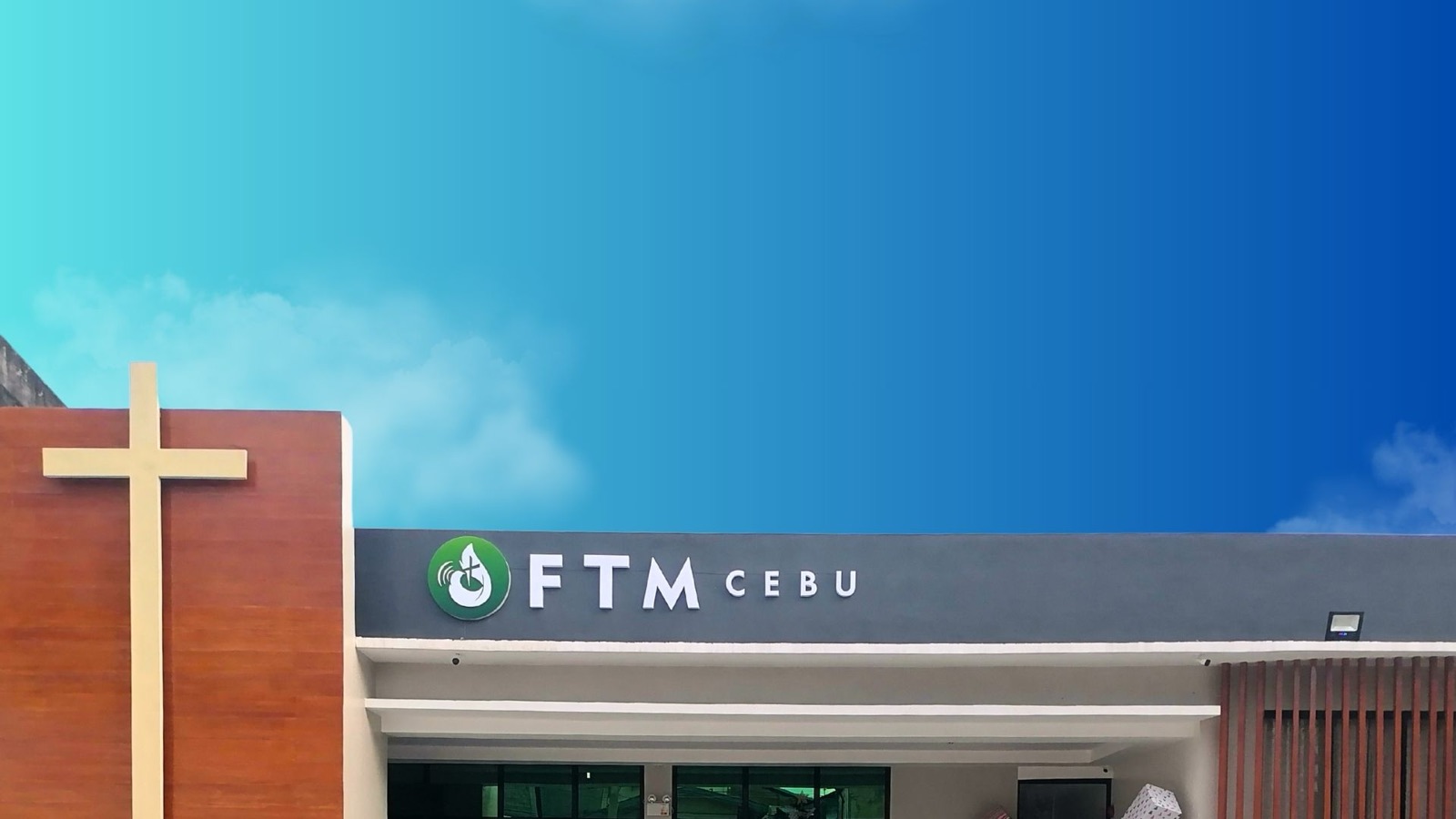 The front of the church in Mabolo: a tall cross beside the FTM Cebu sign.